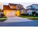 Charming home with well-manicured lawn, two-car garage, and inviting front entrance at 5018 Tupelo Ct, Minneola, FL 34715