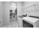 Laundry room with washer, dryer, and white wire shelving at 5018 Tupelo Ct, Minneola, FL 34715