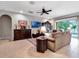 Spacious living room featuring tile floors and large windows with natural light and backyard views at 5018 Tupelo Ct, Minneola, FL 34715