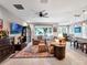 Open-concept living room featuring tile floors, a ceiling fan and a large window overlooking the yard at 5018 Tupelo Ct, Minneola, FL 34715