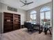 Bright office with built in bookshelves, desk, ceiling fan, and large windows at 5018 Tupelo Ct, Minneola, FL 34715