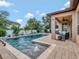 Inviting backyard pool with a relaxing lounge area and lush tropical landscaping provides a private oasis at 5018 Tupelo Ct, Minneola, FL 34715