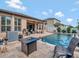 Backyard with an in-ground pool, outdoor seating and manicured landscaping at 5018 Tupelo Ct, Minneola, FL 34715