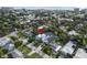 Aerial view of neighborhood showcasing the home's location among mature trees and other residential properties at 507 S Pine St, New Smyrna Beach, FL 32169