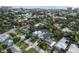 Aerial view of community with lush landscaping and mature trees with swimming pool at 507 S Pine St, New Smyrna Beach, FL 32169