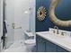 Chic bathroom with a modern vanity, decorative mirror, and stylish glass-enclosed shower at 507 S Pine St, New Smyrna Beach, FL 32169