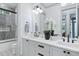 Elegant bathroom with double sinks, white countertops, dark hardware, and decorative mosaic tile flooring in the toilet area at 507 S Pine St, New Smyrna Beach, FL 32169
