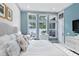 Inviting bedroom with white walls, white furniture and a large window overlooking the pool at 507 S Pine St, New Smyrna Beach, FL 32169