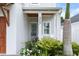 Inviting front entrance featuring a stylish front door, decorative plants, and a covered porch with cozy seating at 507 S Pine St, New Smyrna Beach, FL 32169