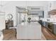 Bright kitchen with marble island and stainless steel appliances adjacent to dining room at 507 S Pine St, New Smyrna Beach, FL 32169
