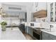 Beautiful kitchen featuring grey cabinets, stainless appliances, and a subway tile backsplash at 507 S Pine St, New Smyrna Beach, FL 32169