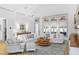 Comfortable living room featuring shiplap walls, ceiling beams, and hardwood floors at 507 S Pine St, New Smyrna Beach, FL 32169