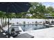 Beautiful backyard pool surrounded by lush greenery, featuring comfortable lounge chairs and a relaxing atmosphere at 507 S Pine St, New Smyrna Beach, FL 32169