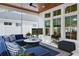 Comfortable porch area with plush seating, a modern ceiling fan, and a television for entertainment at 507 S Pine St, New Smyrna Beach, FL 32169
