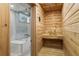 Inviting cedar sauna featuring built-in bench, wooden bucket, and a glass door at 507 S Pine St, New Smyrna Beach, FL 32169