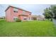 Spacious backyard, fully fenced, features lush green grass and ample room for recreation and relaxation at 547 Brighton Ct, Kissimmee, FL 34758