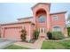 Charming two-story home with landscaped yard, a two car garage, and beautiful front door at 547 Brighton Ct, Kissimmee, FL 34758
