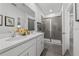 Bright bathroom features a double vanity, large mirror, and glass-enclosed shower at 5630 Stockade Blvd, St Cloud, FL 34771