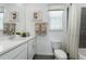 Bathroom showcasing double vanity, a toilet, and shower with patterned curtain at 5630 Stockade Blvd, St Cloud, FL 34771