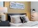 Bedroom with decorative pillows and bedside table with lamp and fishing decor at 5630 Stockade Blvd, St Cloud, FL 34771
