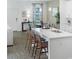 Open-concept kitchen with a central island, modern appliances, and dining area at 5630 Stockade Blvd, St Cloud, FL 34771