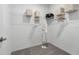 Organized walk-in closet with shelving, clothes racks, and carpeted flooring at 5630 Stockade Blvd, St Cloud, FL 34771