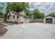 Large backyard with a spacious concrete pad, detached garage, and brick accents at 622 S Ingraham Ave, Lakeland, FL 33801