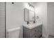 Comfortable bathroom featuring double vanity, square mirror, and modern sink fixtures at 622 S Ingraham Ave, Lakeland, FL 33801