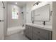 Renovated bathroom with gray vanity, double sinks, and modern finishes at 622 S Ingraham Ave, Lakeland, FL 33801