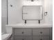 Bathroom with double vanity, square mirror, and modern sink fixtures at 622 S Ingraham Ave, Lakeland, FL 33801