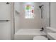 Bright bathroom features modern fixtures and a unique stained-glass window above the tub at 622 S Ingraham Ave, Lakeland, FL 33801