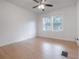 Cozy bedroom features hardwood floors, ceiling fan, and natural lighting at 622 S Ingraham Ave, Lakeland, FL 33801