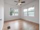 Bright bedroom featuring hardwood floors, ceiling fan, and plenty of natural light at 622 S Ingraham Ave, Lakeland, FL 33801