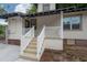 Inviting front porch with white railings and stairs leading to the home's entrance at 622 S Ingraham Ave, Lakeland, FL 33801