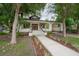 Charming home with a welcoming front porch, landscaped yard, and convenient carport at 622 S Ingraham Ave, Lakeland, FL 33801