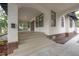 Exterior elevation showing a covered porch, brick accents and an inviting arched entry at 622 S Ingraham Ave, Lakeland, FL 33801
