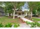 Charming home with a welcoming front porch, landscaped yard, and convenient carport at 622 S Ingraham Ave, Lakeland, FL 33801