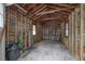 Interior of garage showcasing exposed wood framing and concrete flooring at 622 S Ingraham Ave, Lakeland, FL 33801