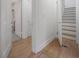 Hallway with hardwood floors leading to bathroom and staircase at 622 S Ingraham Ave, Lakeland, FL 33801