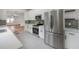 Well-equipped kitchen with stainless steel appliances and green subway tile, seamlessly flowing into the living area at 622 S Ingraham Ave, Lakeland, FL 33801