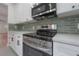 Modern kitchen features stainless steel appliances, white cabinets, and sleek countertops at 622 S Ingraham Ave, Lakeland, FL 33801