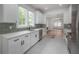 Bright kitchen with white cabinets, subway tile backsplash, stainless appliances, and an open flow to the living area at 622 S Ingraham Ave, Lakeland, FL 33801