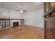 Bright living room with hardwood floors, a cozy fireplace, and stylish built-in shelving at 622 S Ingraham Ave, Lakeland, FL 33801