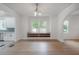 Open-concept living room featuring hardwood floors, stylish chandelier, and built-in window seating with storage at 622 S Ingraham Ave, Lakeland, FL 33801