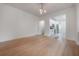 Inviting living room with hardwood floors leading to a modern kitchen with white cabinets and stainless appliances at 622 S Ingraham Ave, Lakeland, FL 33801