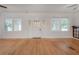 Spacious living room with hardwood floors, a decorative front door, and large windows at 622 S Ingraham Ave, Lakeland, FL 33801