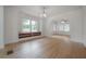 Spacious living room with hardwood floors, large windows, built-in storage, and neutral walls at 622 S Ingraham Ave, Lakeland, FL 33801