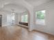 Bright living room with hardwood floors, arched doorway, and built-in drawers beneath a bay window at 622 S Ingraham Ave, Lakeland, FL 33801