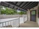 Relaxing porch featuring exterior door, sleek railing, and block fence at 622 S Ingraham Ave, Lakeland, FL 33801