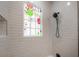 Tiled shower offers modern design elements, complemented by bright window at 622 S Ingraham Ave, Lakeland, FL 33801
